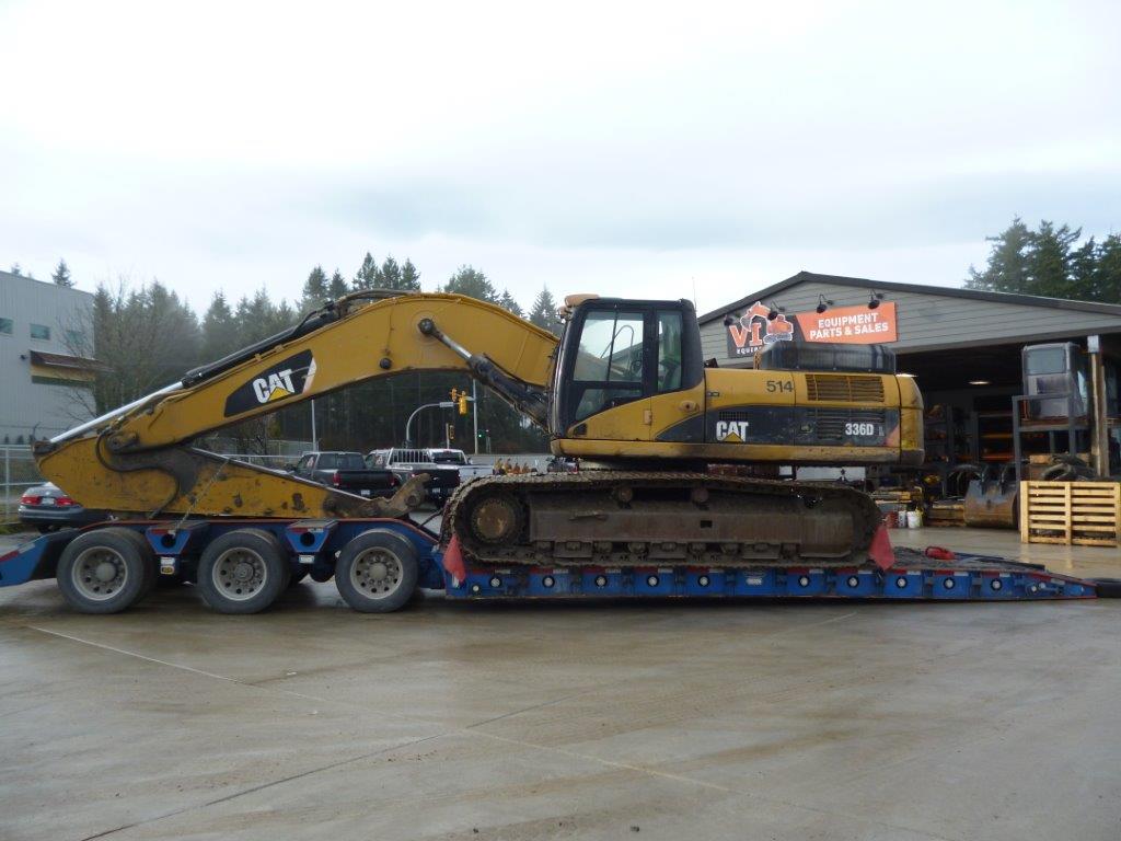 a yellow tractor on a flatbed trailer