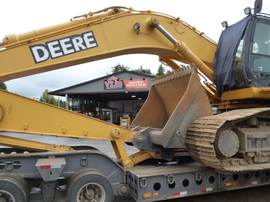 a large yellow tractor with a bucket on a trailer