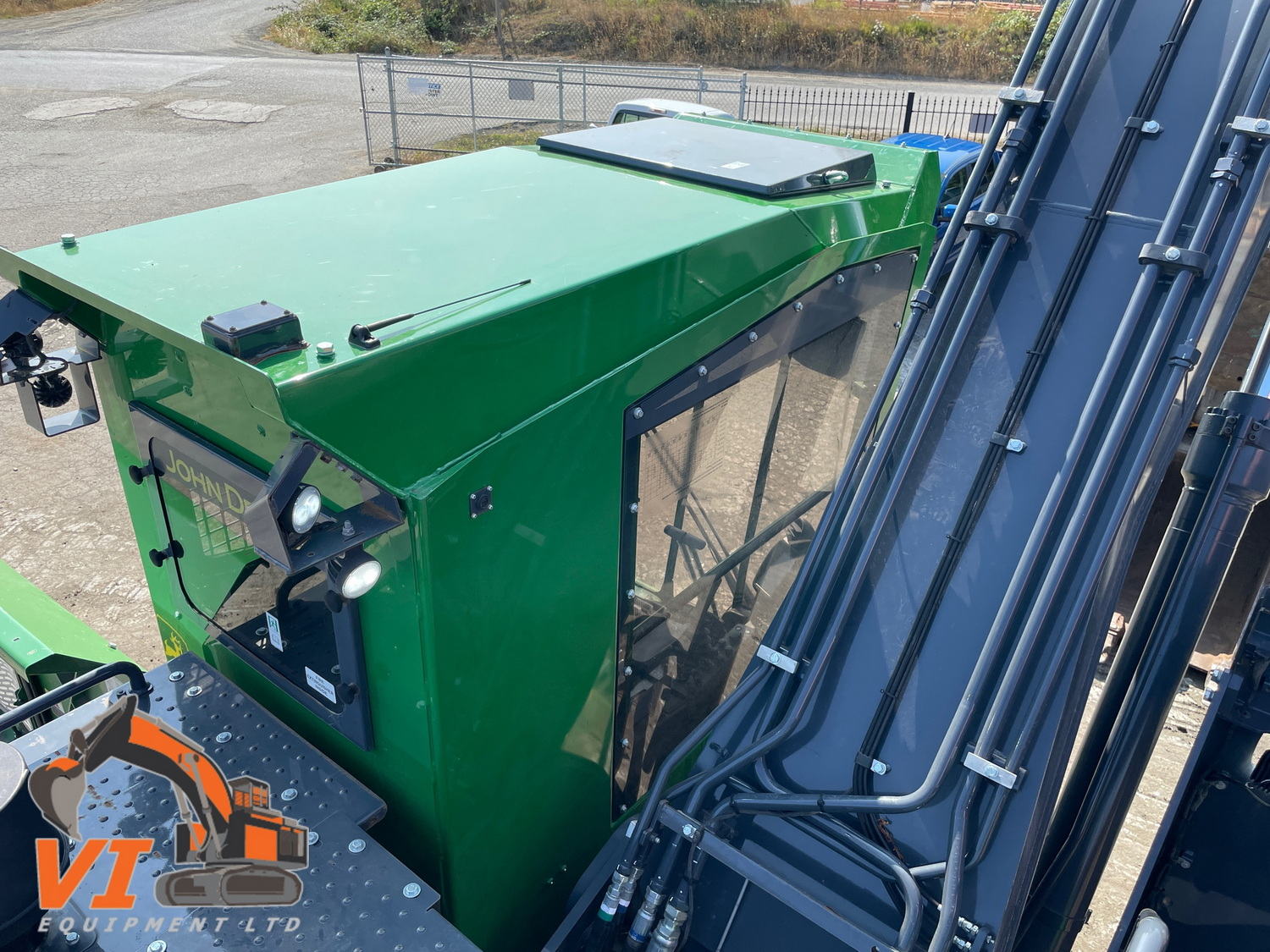 a green tractor with a ladder